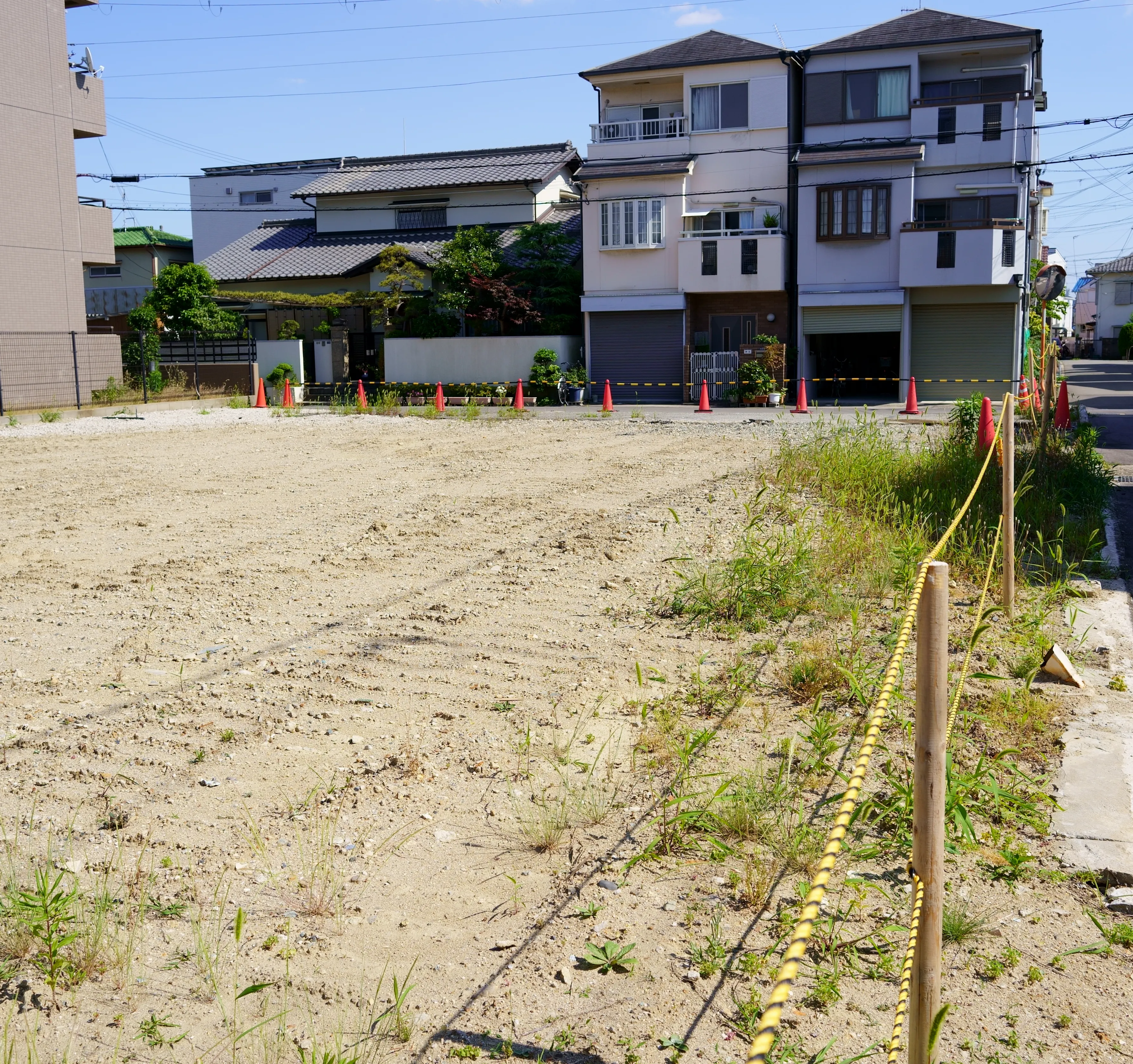 更地の写真、周囲に住宅が並ぶ